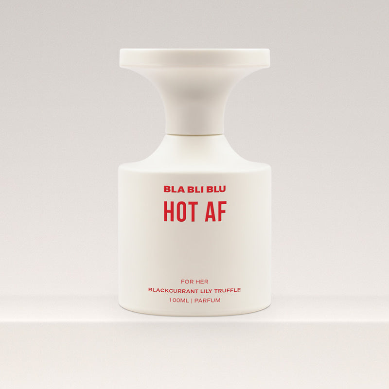 White perfume bottle with red text on a light gray background