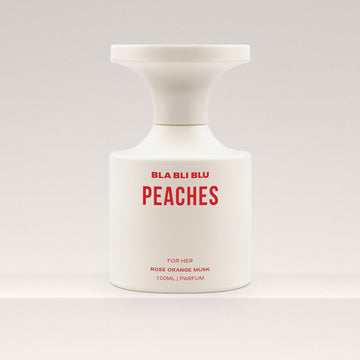 Perfume bottle labeled 'PEACHES' by BLA BLU on a white background