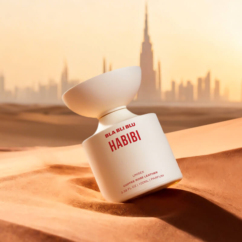 White perfume bottle with red text on a light gray background