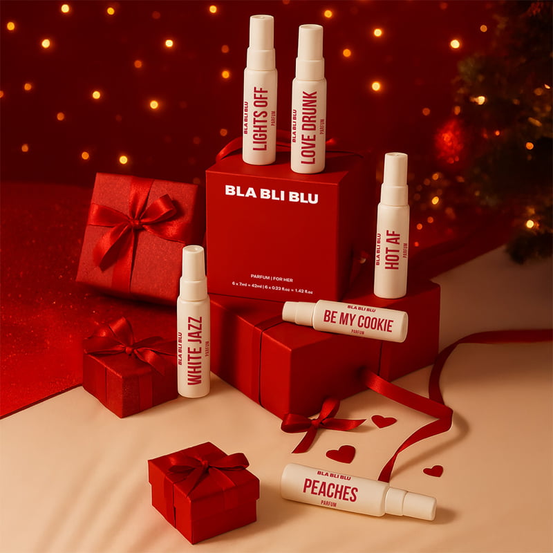 BLA BLU perfume bottles and packaging on a festive background with red ribbons and lights.
