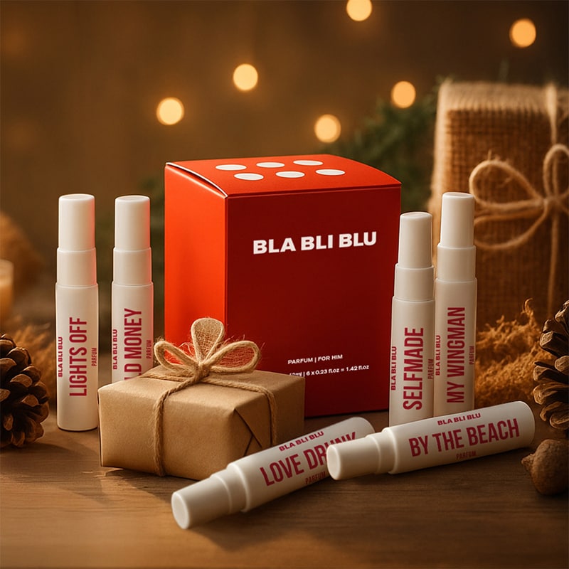 BLA BLI BLU perfume bottles and packaging on a wooden surface with a warm, blurred background.