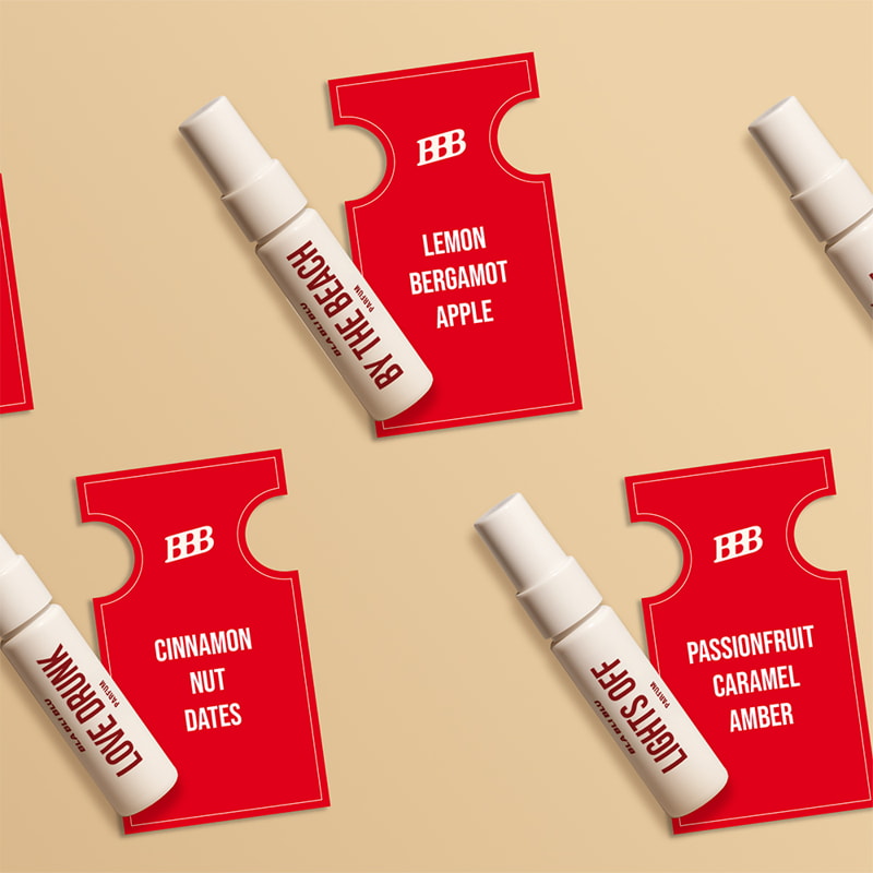 Red and white perfume bottles with labels on a beige background