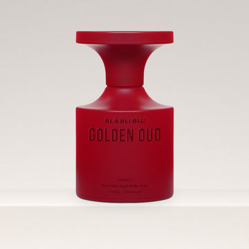 Red perfume bottle labeled 'Golden Oud Perfume' on a white background