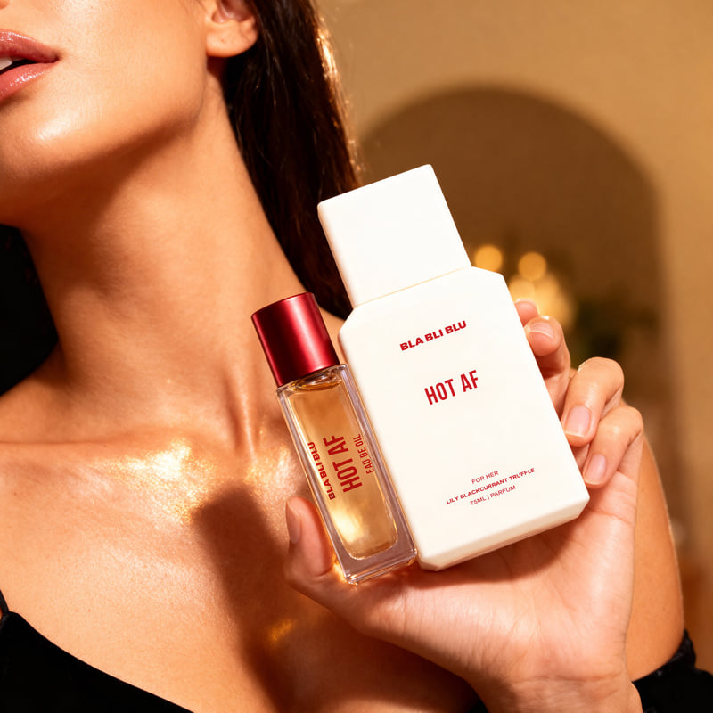 Person holding two 'BLAU BLU HOT AF' perfume bottles.
