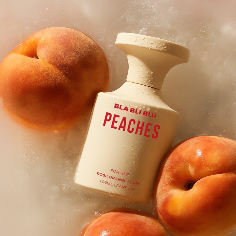 Perfume bottle labeled 'PEACHES' by BLA BLU on a white background