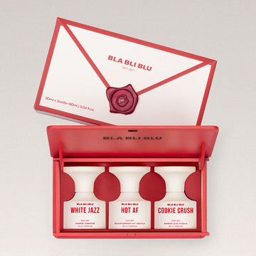 perfume gift set for women with three bottles inside an open red box.