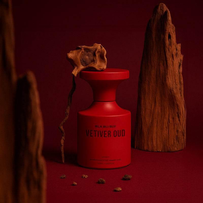 Red vetiver  perfume bottle labeled 'Vetiver Oud' on a light gray background