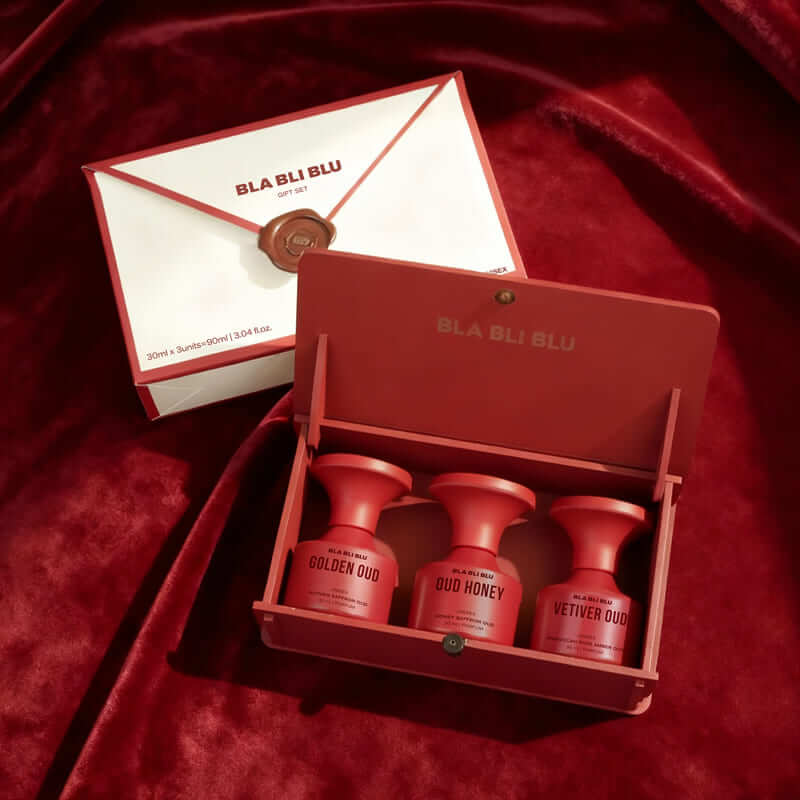 Red 'BLA BLU'  oud gift set product set on a red fabric background